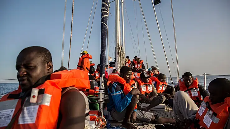 Central Mediterranean migrant rescue operation saving African migrants from overcrowded boat