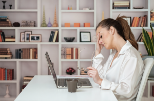 A mentally exhausted woman surrounded by work, family responsibilities, and emotional pressure