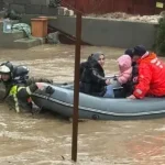 Flooded street in Makhachkala with water reaching houses.