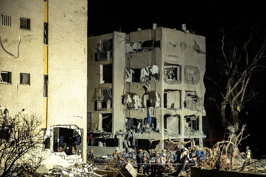 Emergency responders at southern Israeli town after Iranian missile attack injuring 160 people near nuclear site