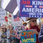 No Kings protests USA crowd holding anti-Trump signs in major city streets