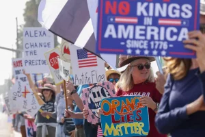 No Kings protests USA crowd holding anti-Trump signs in major city streets