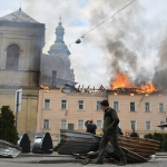 Man walks past burning building after Russian drone attack in Lviv Ukraine