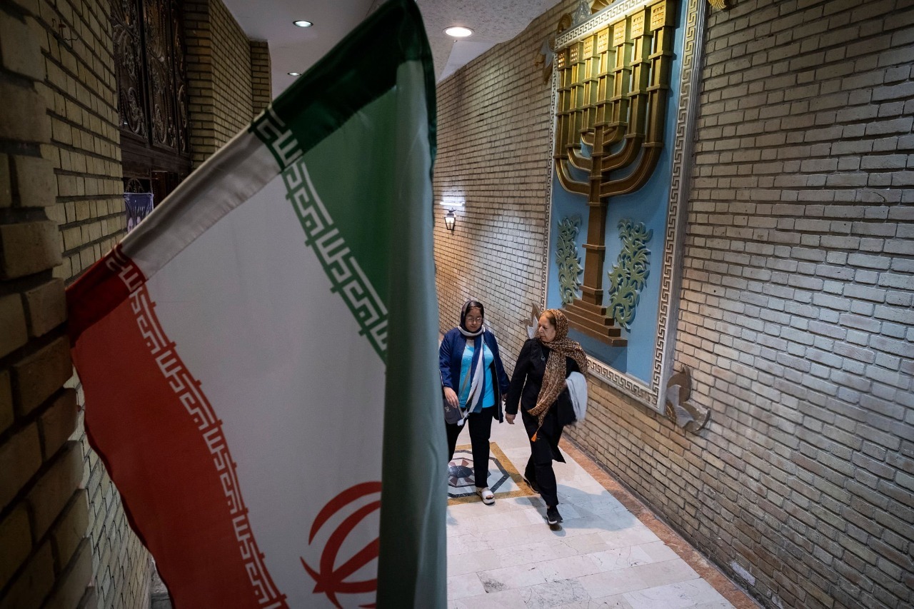 Iranian-Jewish women walking inside Tehran synagogue during prayer ceremony amid ceasefire tensions April 2026