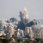 Smoke rising from Israeli airstrike near Tyre, Lebanon, showing damaged buildings and affected area
