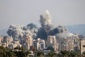 Smoke rising from Israeli airstrike near Tyre, Lebanon, showing damaged buildings and affected area