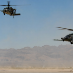 US rescue helicopters flying over rugged mountains in Iran during search for missing crew member